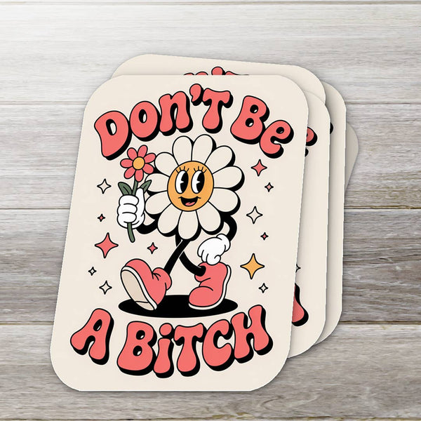 Card with cartoon character holding a flower and text 'Don't Be A Bitch' on a wooden surface