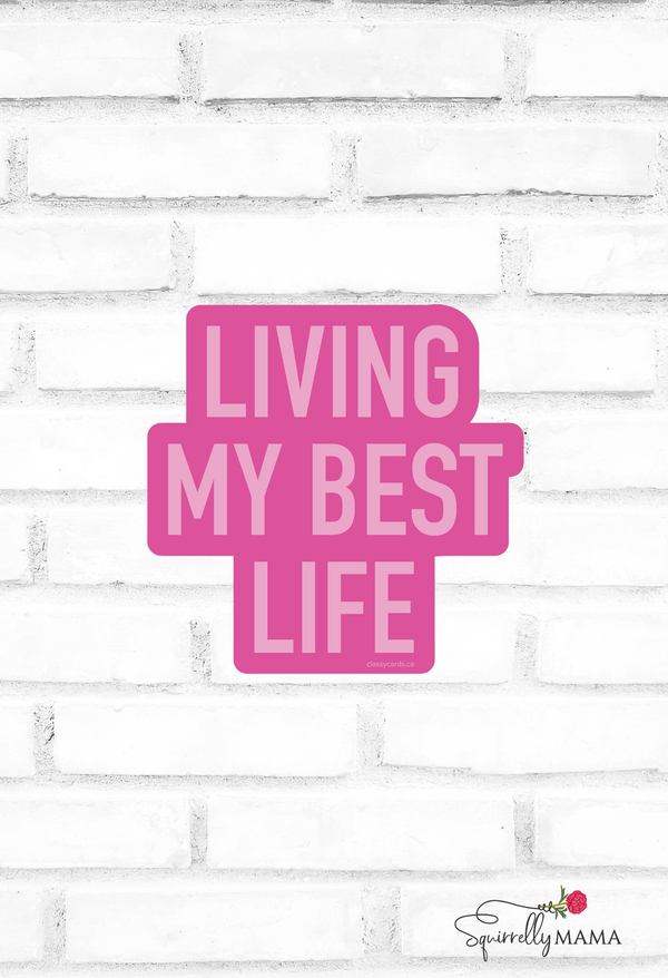 Pink text 'Living My Best Life' on a white brick wall background