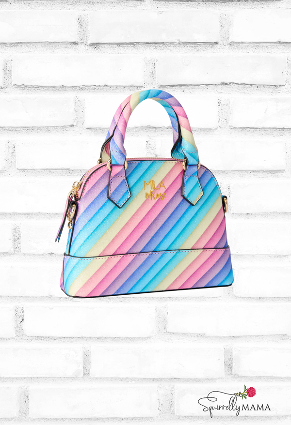 Colorful striped handbag on a white brick background