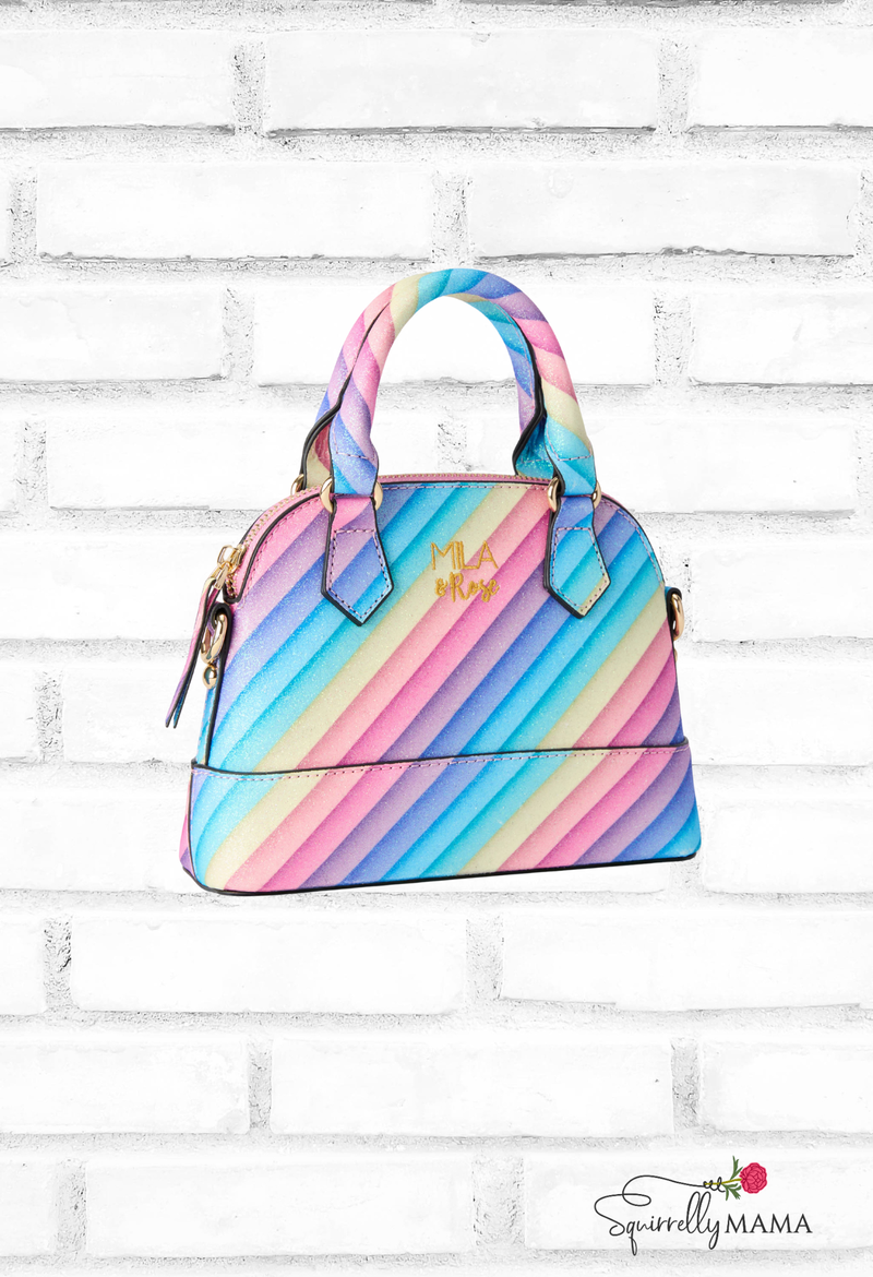 Colorful striped handbag on a white brick background