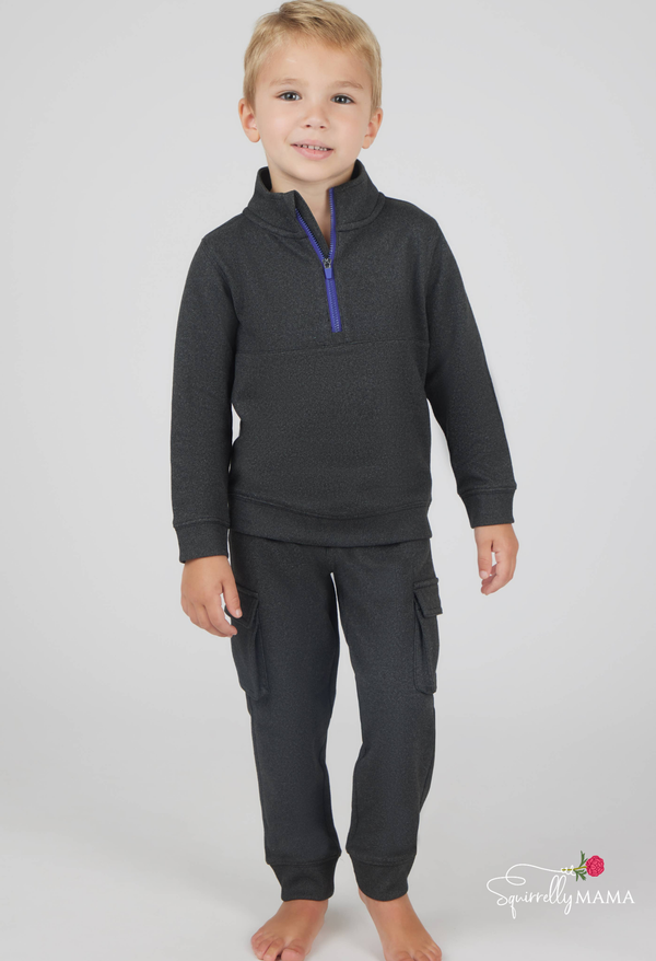 fleece charcoal gray sweatsuit on a young boy with a blue zipper detail