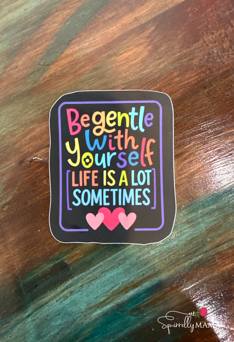 Colorful sticker with motivational quote on a wooden surface