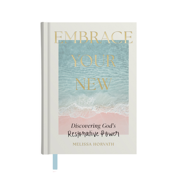 Cover of the 'Embrace Your New' devotional book with an image of a serene beach scene and the title text overlay.