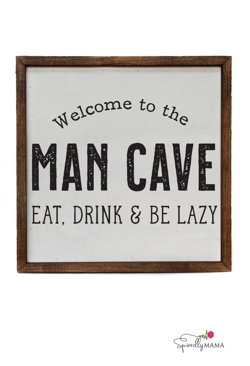 Wooden sign that says ‘Welcome to the Man Cave – Eat, Drink & Be Lazy’ with rustic brown frame.
