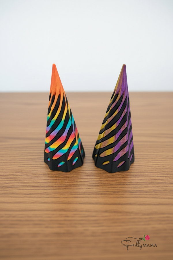 Two colorful striped cones on a wood background with 'SparklyMama' branding.